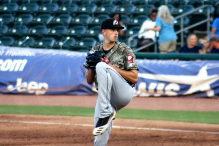 Adam Hill pitching for Arkansas