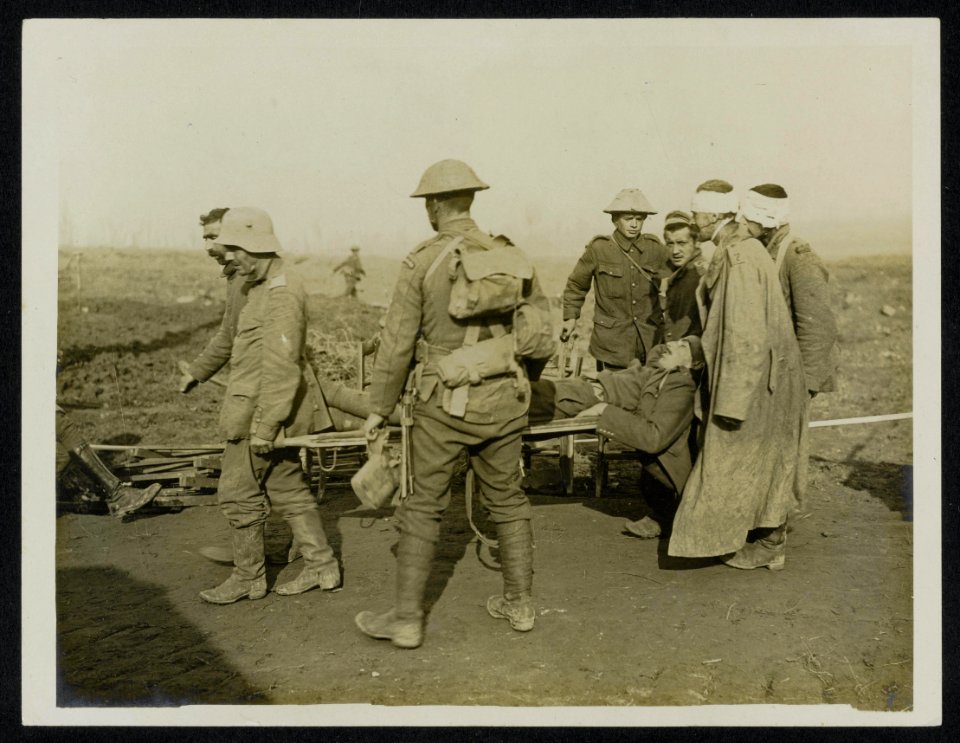 A wounded Guards officer being carried in by German prisoners, Bestanddeelnr 158-0447