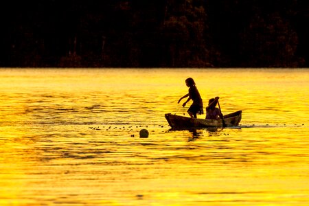 Dugout canoe lagoon silhouette widi islands