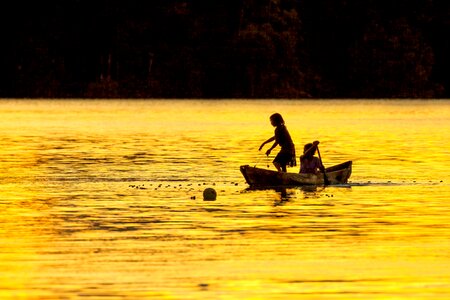 Dugout canoe lagoon silhouette widi islands photo