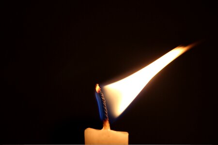 Light burning black candle photo