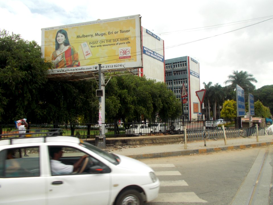An Advertisement about various silks beside silk board
