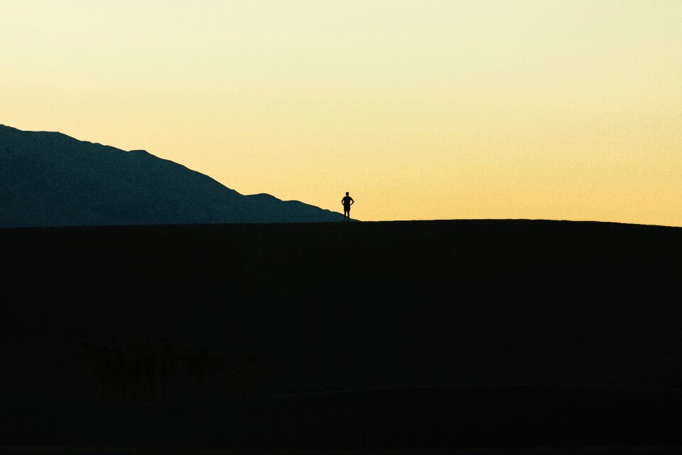 Silhouette standing gray mountain