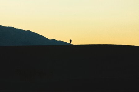 Silhouette standing gray mountain photo
