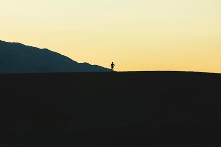 Silhouette standing gray mountain