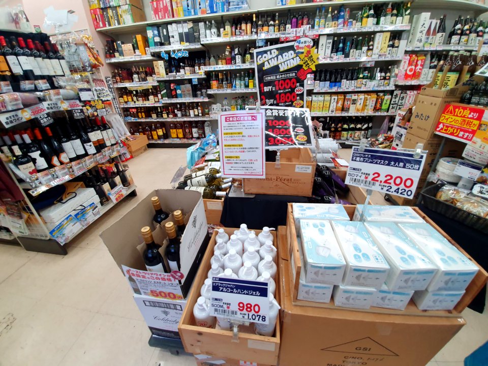 Alcohol disinfectant and masks for sale at the entrance of a liquor shop