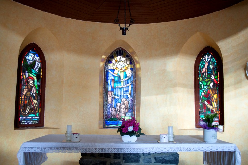 Altar and stained glass windows in the Galyatető Roman Catholic church