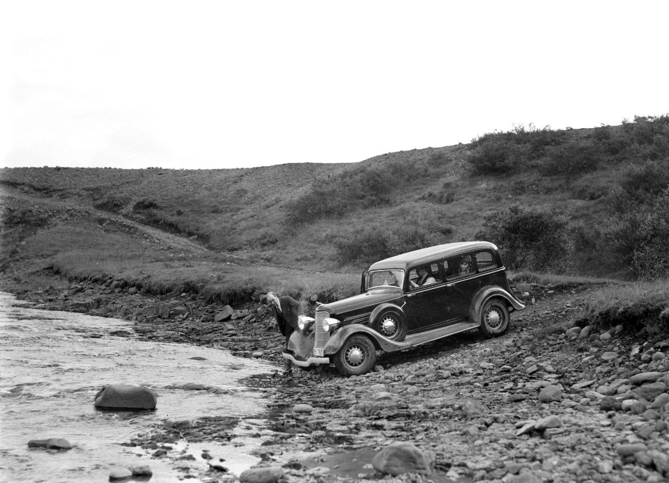 Auto bij een beek aan een smalle weg in een rotsachtig landschap. Een van de pas, Bestanddeelnr 190-0294