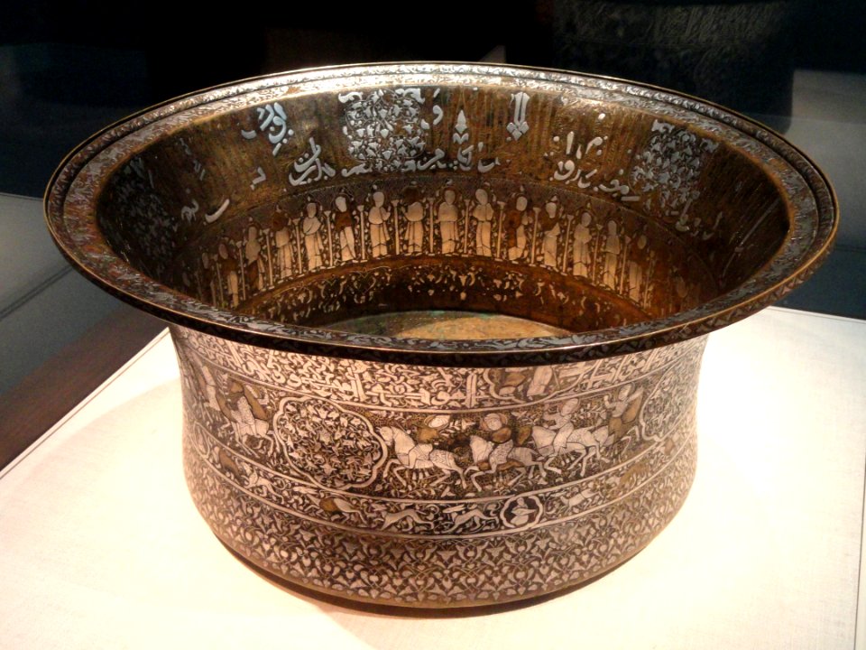 Basin with Christian and Islamic motifs, probably northern Iraq, mid 13th century AD, brass inlaid with silver, view 1 - Freer Gallery of Art - DSC05379