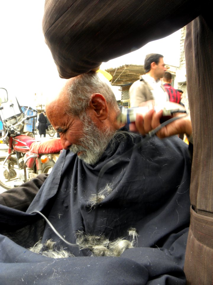 Barber on the sidewalk of a street in Nishapur 7
