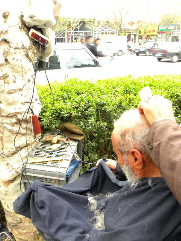 Barber on the sidewalk of a street in Nishapur 2