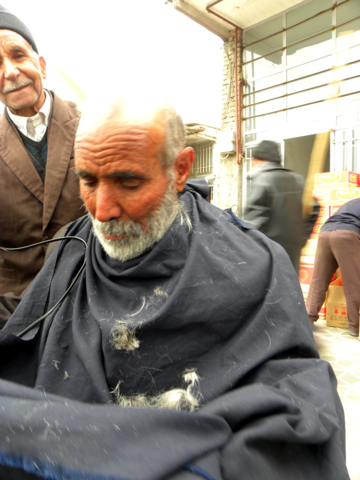Barber on the sidewalk of a street in Nishapur 3
