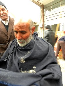 Barber on the sidewalk of a street in Nishapur 3
