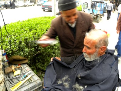 Barber on the sidewalk of a street in Nishapur 6