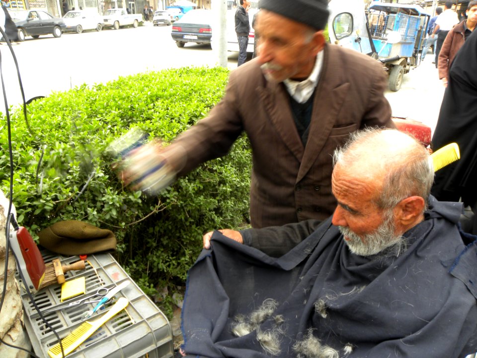 Barber on the sidewalk of a street in Nishapur 5
