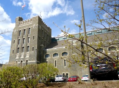 Barton Hall with flag and cars at Cornell University