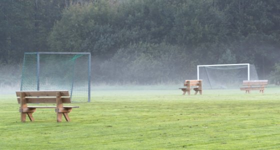 Benches in the mist in soccer training field 2 photo