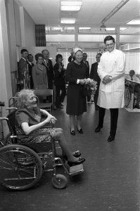 Beatrix tijdens de rondgang met een van de verzorgers Bejaarde in rolstoel, Bestanddeelnr 925-5591