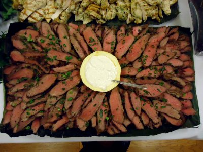 Beef steak slices on a platter with sauce photo