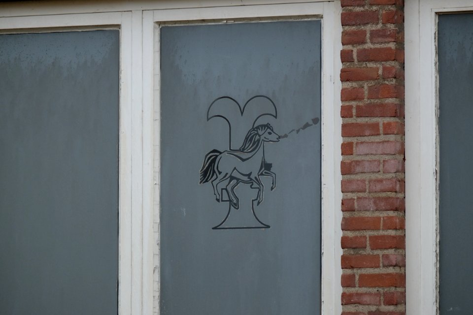 Bemmel town symbol on the old window of an old building