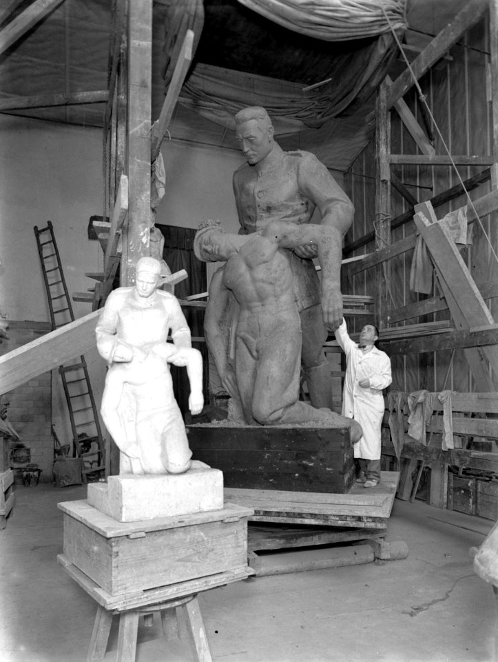 Beeldhouwer Edward Wittig in diens atelier bij een bovenmaats beeld van een mili, Bestanddeelnr 190-0701