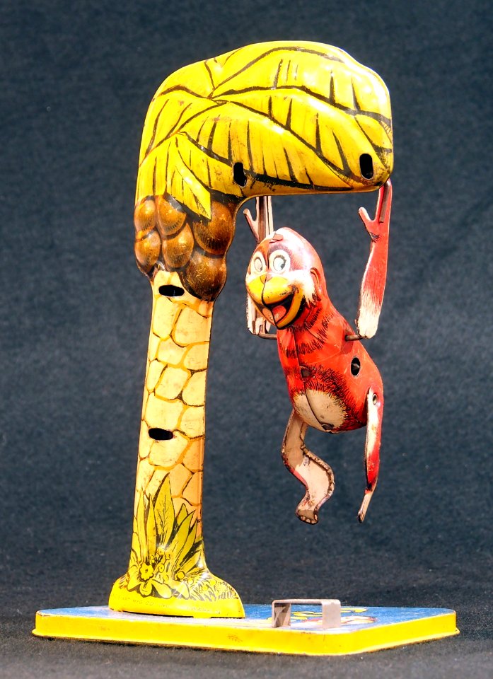 Bombo, tin toy monkey in tree, pic 1