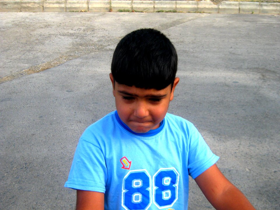 Blue clothed little cyclist boy - cycling near Nishapur railway station 06
