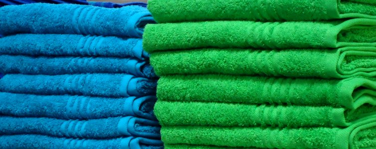 Blue and green towels on a shelf in a store in New Jersey