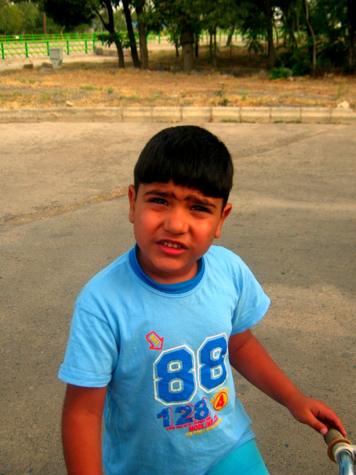 Blue clothed little cyclist boy - cycling near Nishapur railway station 10