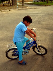 Blue clothed little cyclist boy - cycling near Nishapur railway station 05