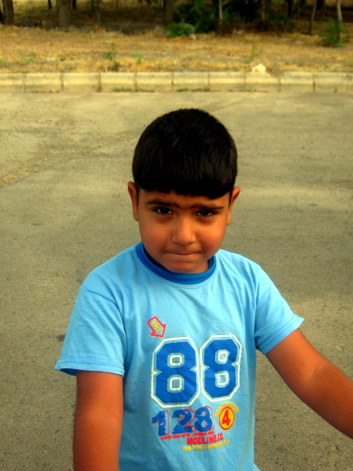 Blue clothed little cyclist boy - cycling near Nishapur railway station 07