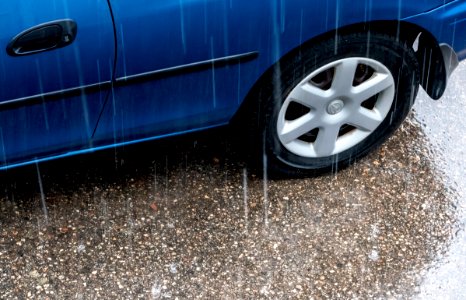 Blue Mazda in the rain 2 photo