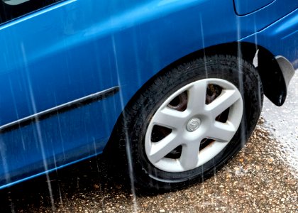 Blue Mazda in the rain 1 photo