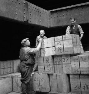 Bijschrift Dockworkers in the hold of a Dutch merchantman Havenarbeiders in, Bestanddeelnr 935-3003