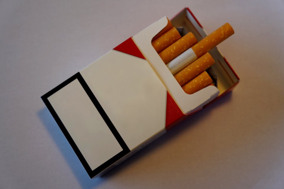 Blank cigarette packet with logo removed and cigarettes sticking out