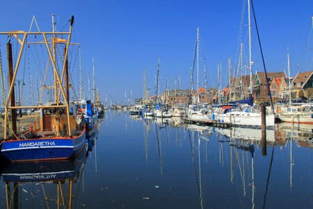 Water mirroring sail masts photo