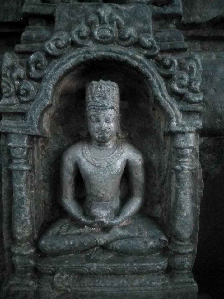 Budha seated under the arch