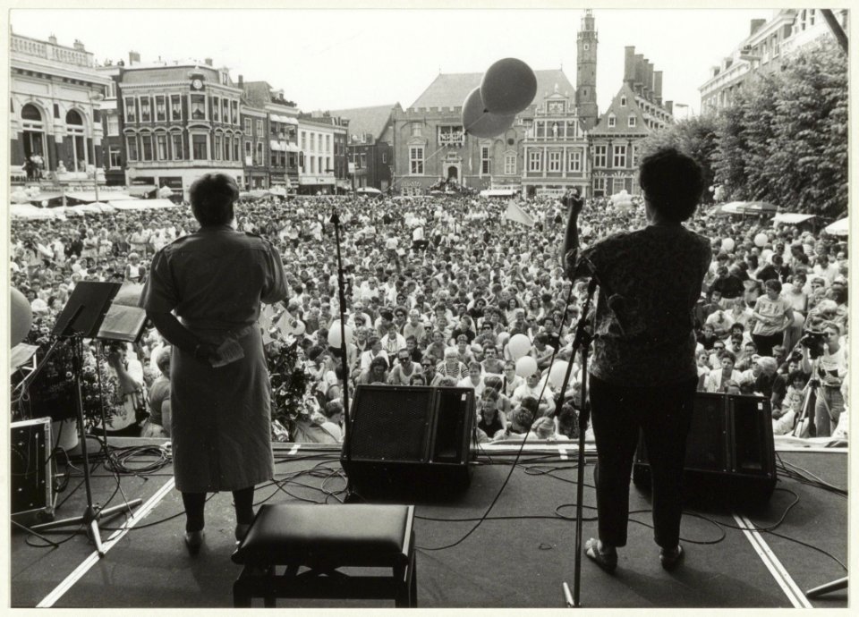 Burgemeester E. Schmitz, bijgestaan door een doventolk, houdt een welkomstspeech op de Grote Markt op Roze Zaterdag . NL-HlmNHA 54031630