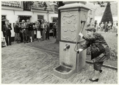 Burgemeester E. Schmitz heropent het hofje van Loo, ook wel genoemd Gasthuishofje, ná de restauratie. NL-HlmNHA 54020872