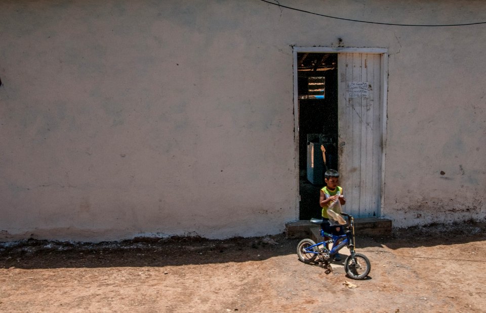 Boy playing in front of his house, Isla Margarita