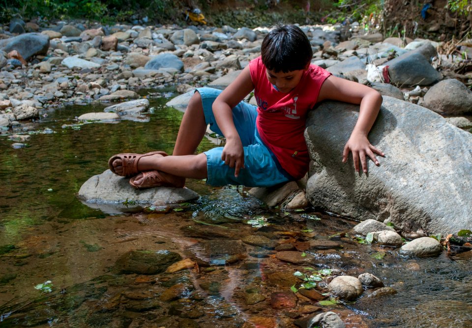 Boy playing in San Juan Bautista River