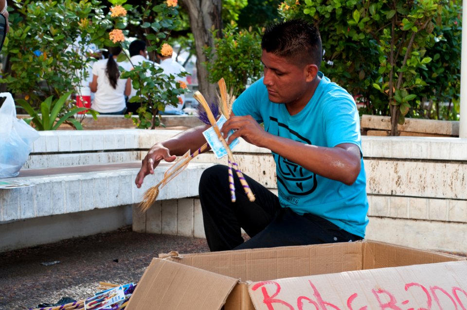 Boy preparing to sell their sacred palms