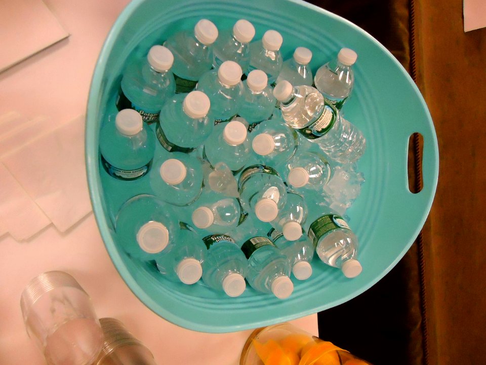 Bottled water in a container with ice water