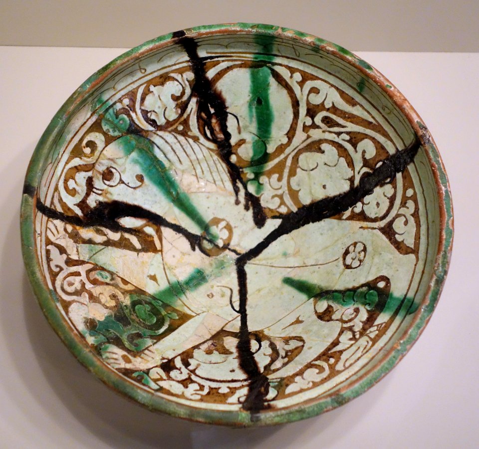 Bowl with prancing lion, Iran, Garrus district, Seljuk period, 12th or 13th century AD, earthenware with carved and painted slip design under transparent glaze with splashes - Cincinnati Art Museum - DSC03985
