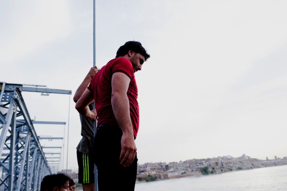 Boys playing and diving at the Old Bridge over the Tigris in Mosul in 2019 during the summertime 13