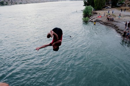 Boys playing and diving at the Old Bridge over the Tigris in Mosul in 2019 during the summertime 14