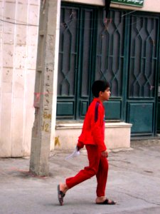 Boy walking - red sport cloths - christ st - Nishapur photo