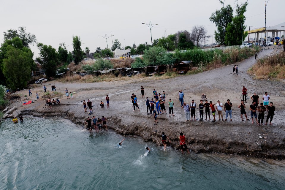 Boys playing and diving at the Old Bridge over the Tigris in Mosul in 2019 during the summertime 12