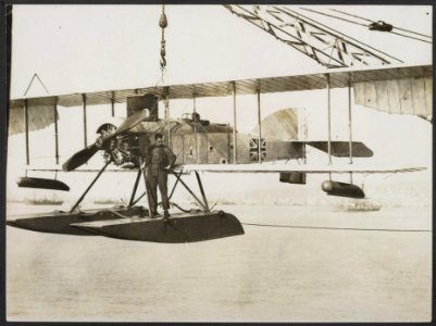 British seaplane being lowered to the water from the parent ship., Bestanddeelnr 158-1989