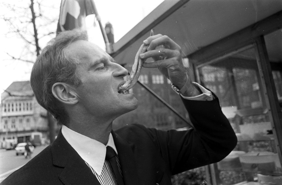 Charlton Heston in Amsterdam. Hier eet hij een haring, Bestanddeelnr 921-2289